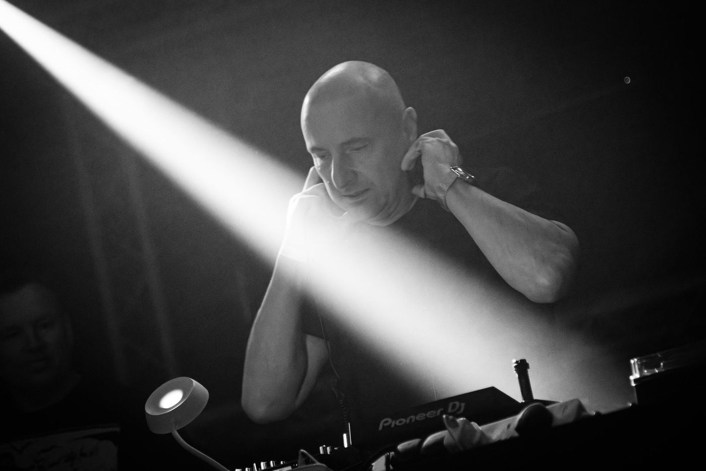 Singer lit by a spotlight beam