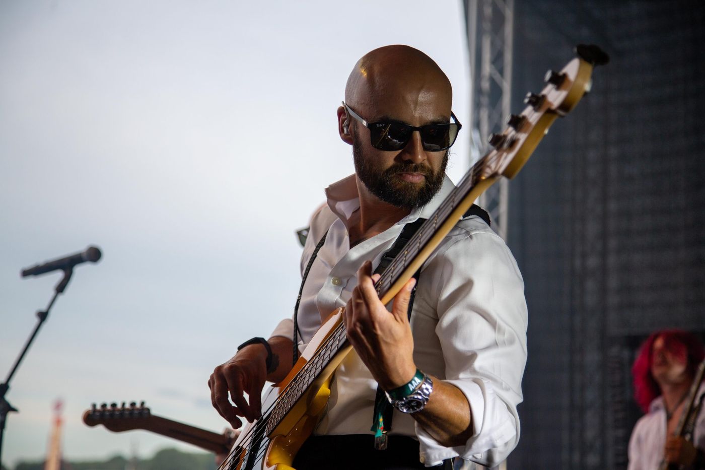 Bassist performing live in sunglasses