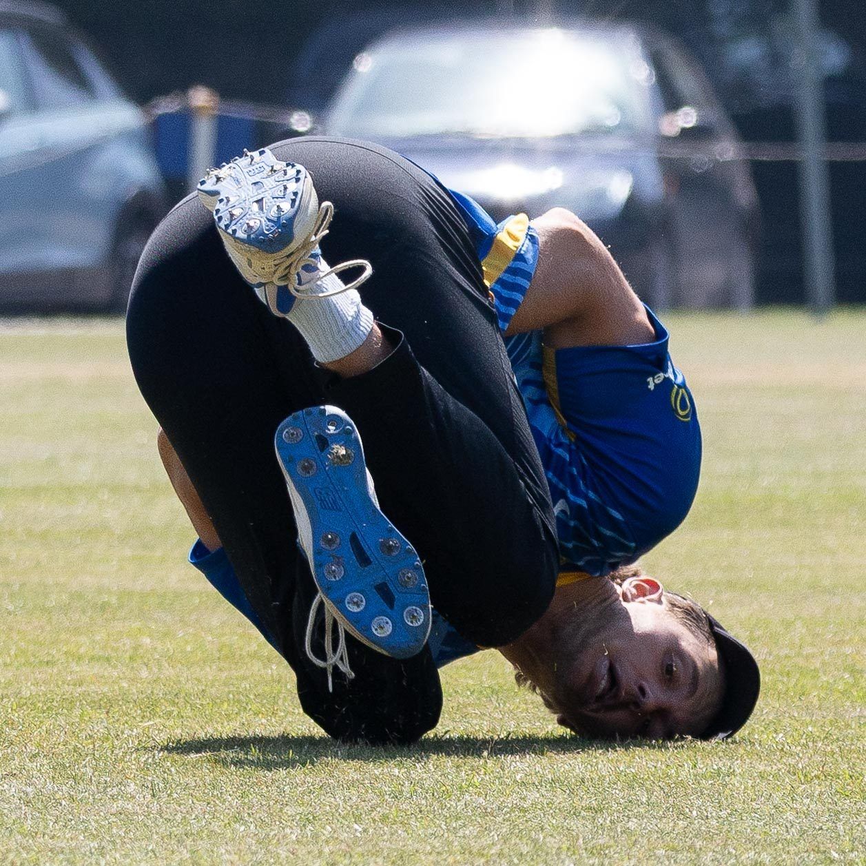 Photographer doing a somersault on the grass
