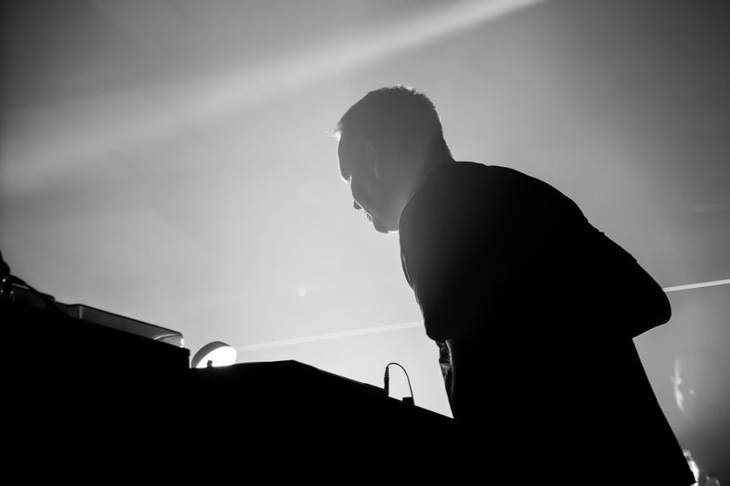 Performer silhouetted against stage light