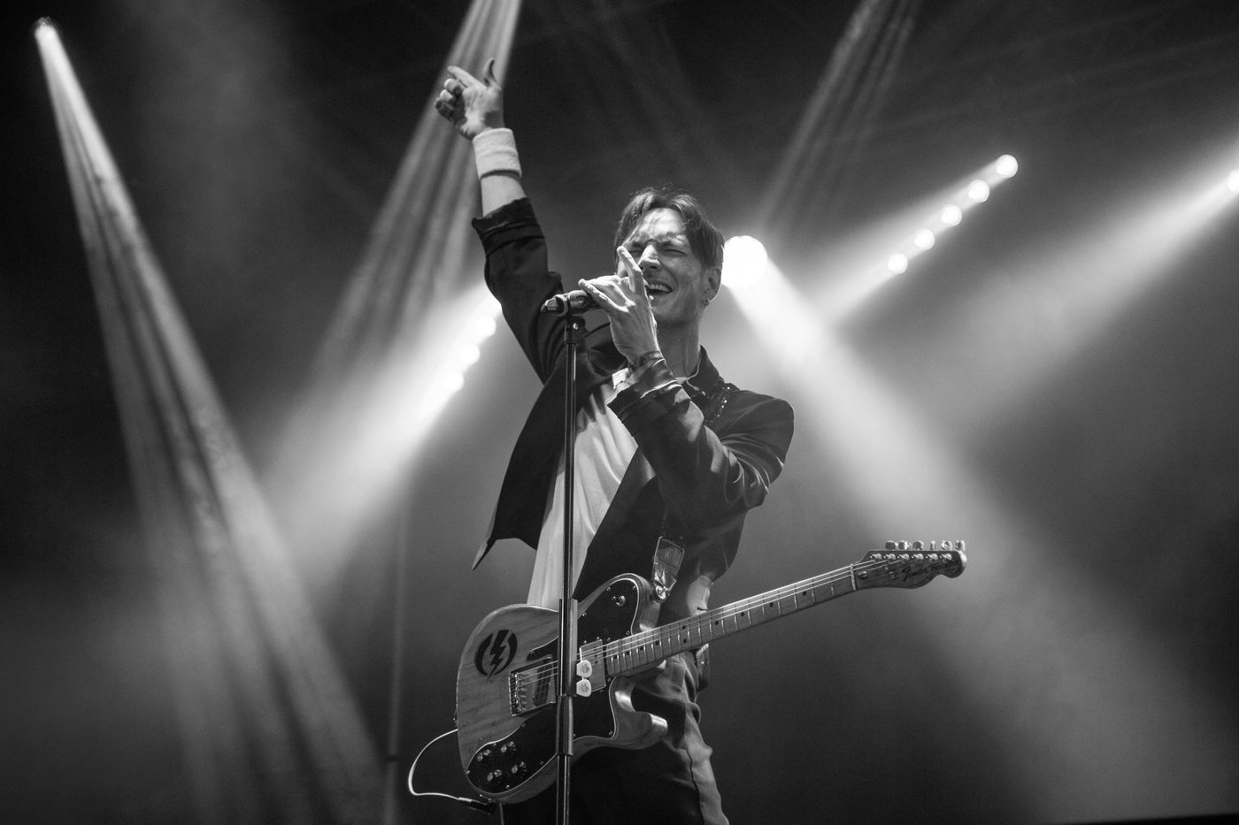 Guitarist performing in black and white stage light