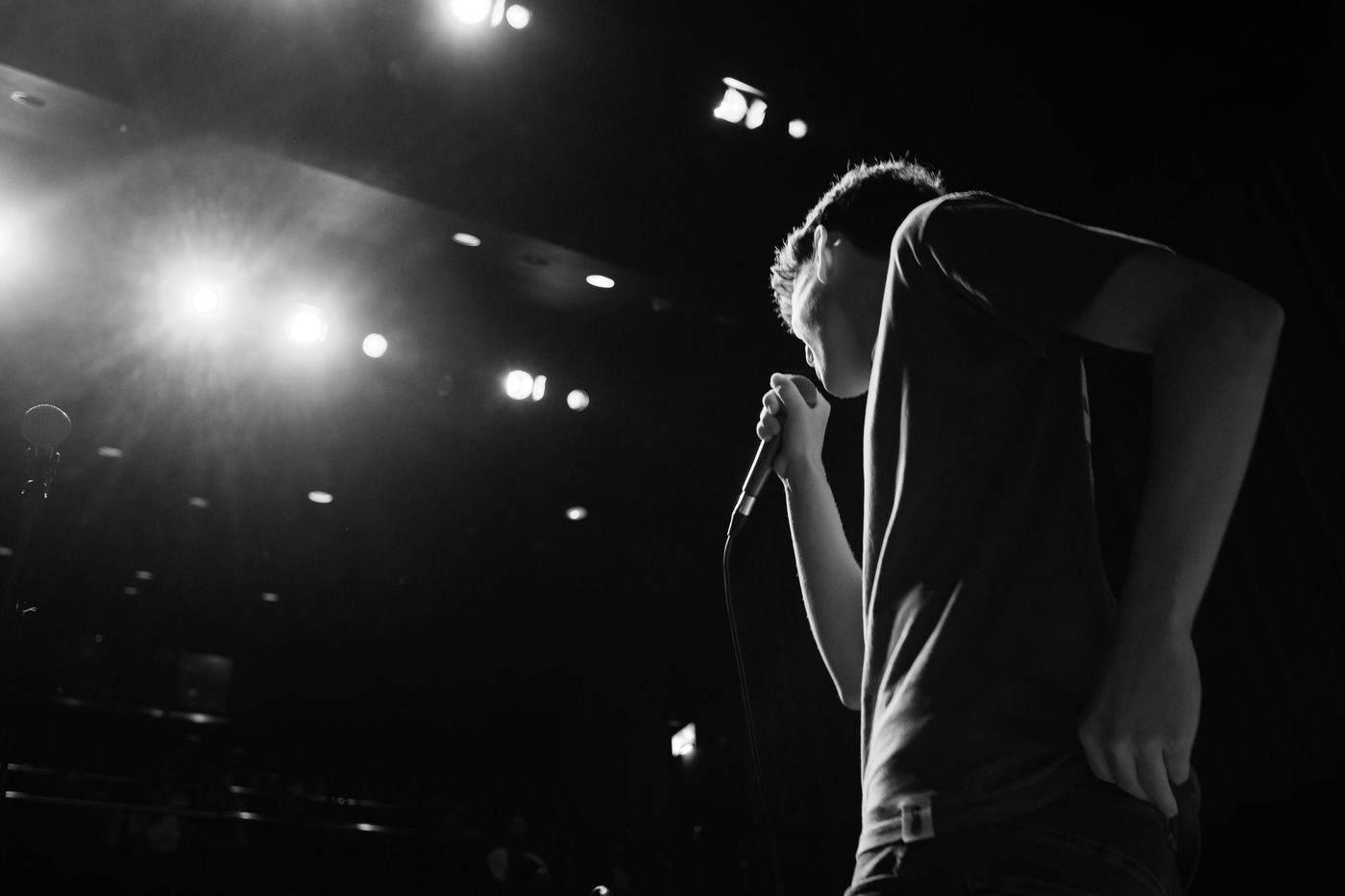 Singer in silhouette at a dark gig