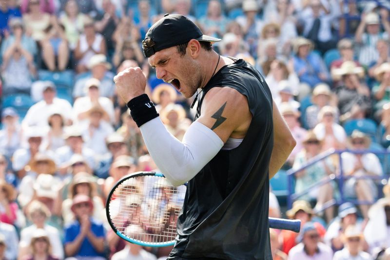 Tennis player celebrating in front of a crowd