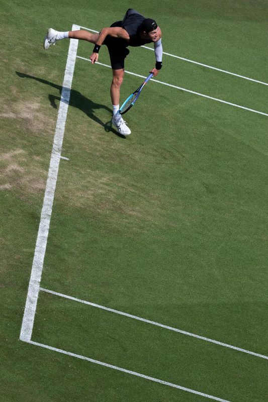 Overhead view of a tennis serve on a grass court