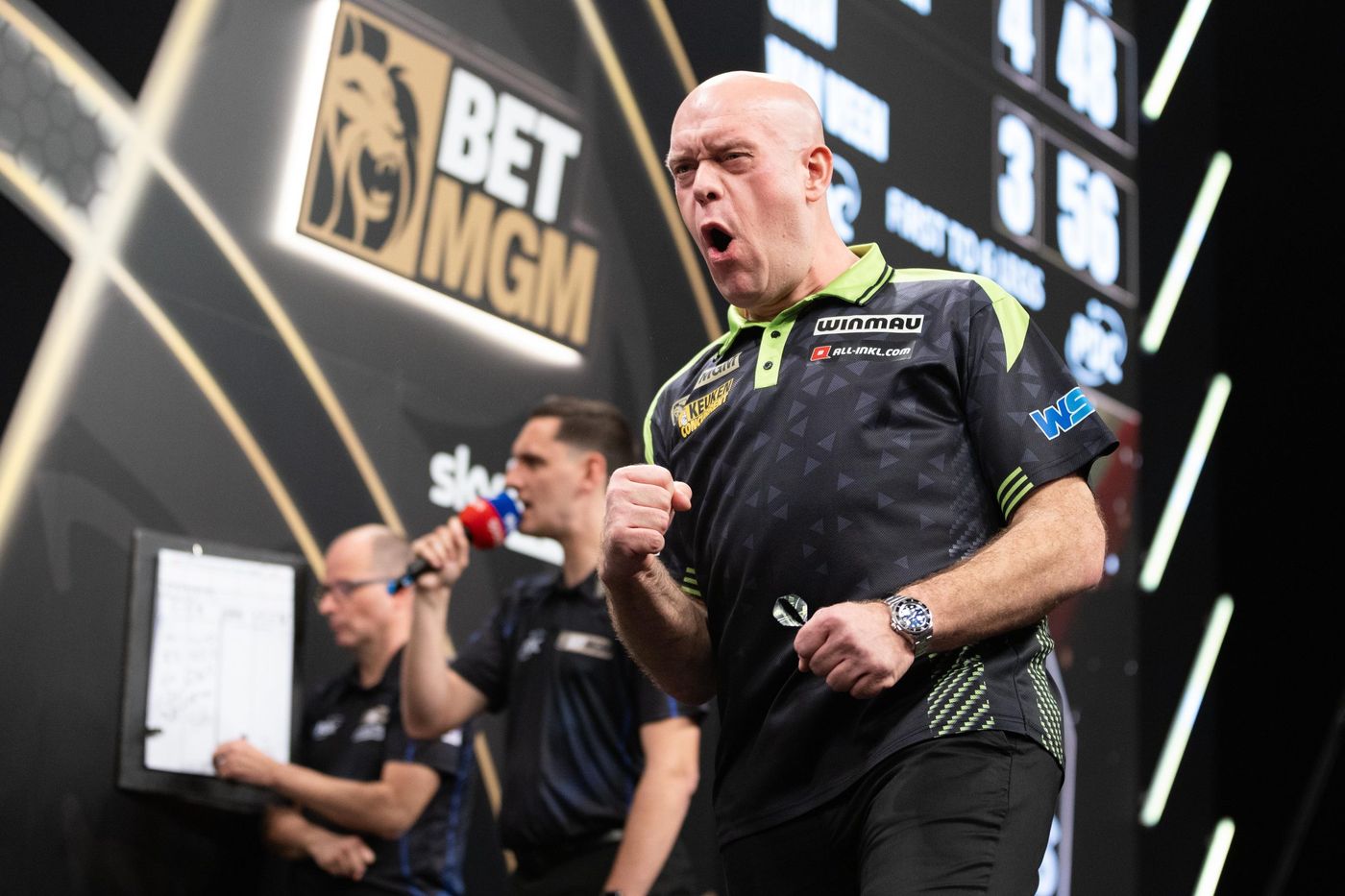 Darts player on stage at a televised event