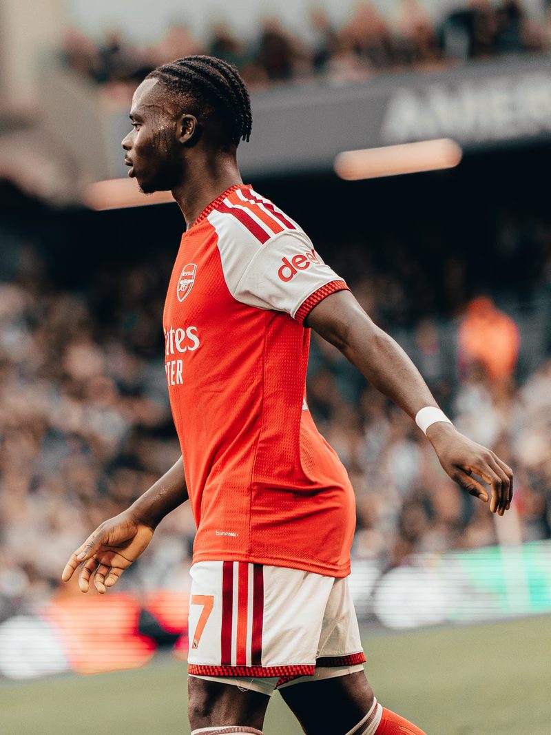 Arsenal player in a red kit on the pitch