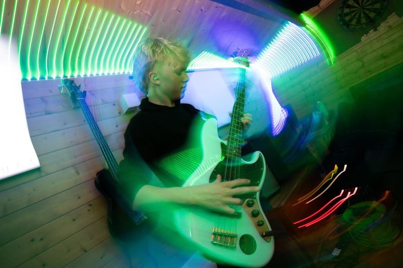 Guitarist in green and blue stage light