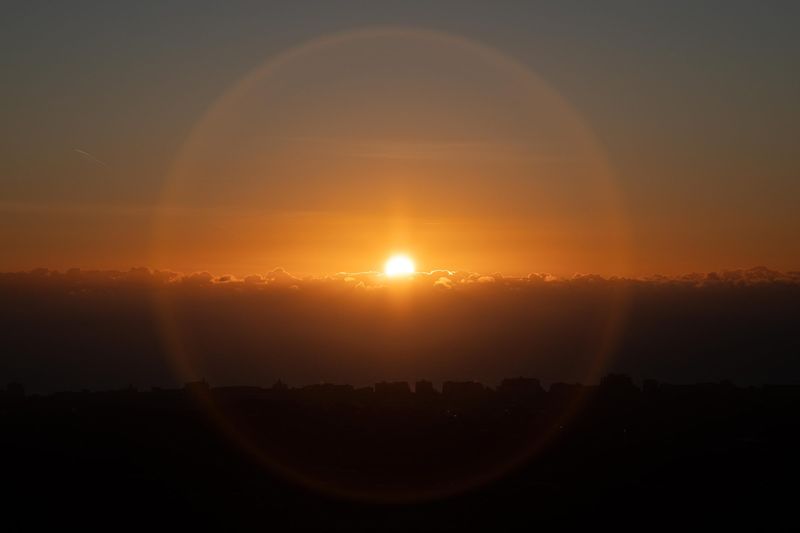 Sun setting over rolling hills