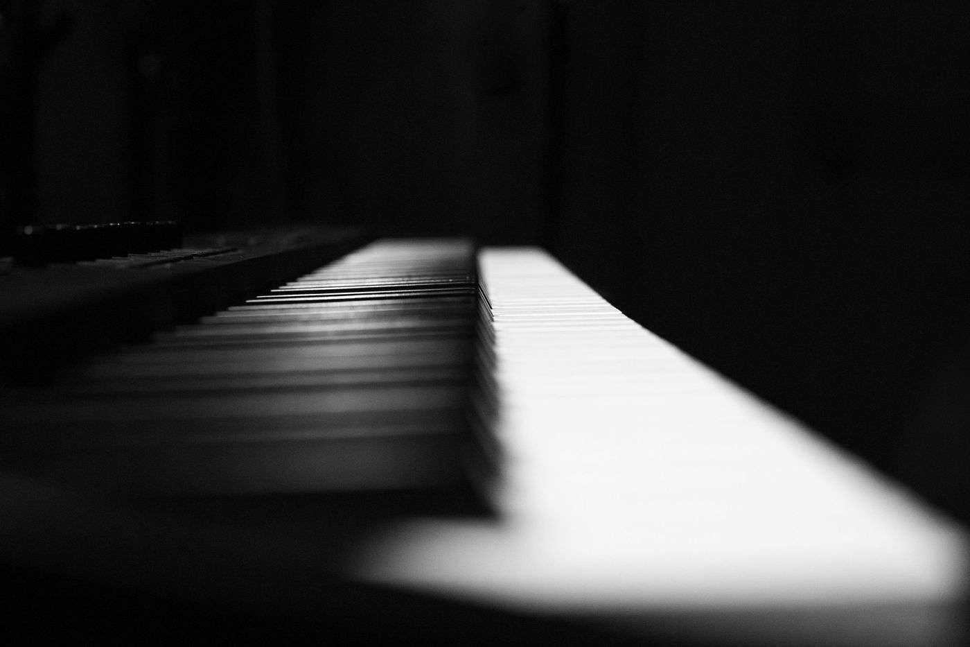 Shadow falling across an empty bench