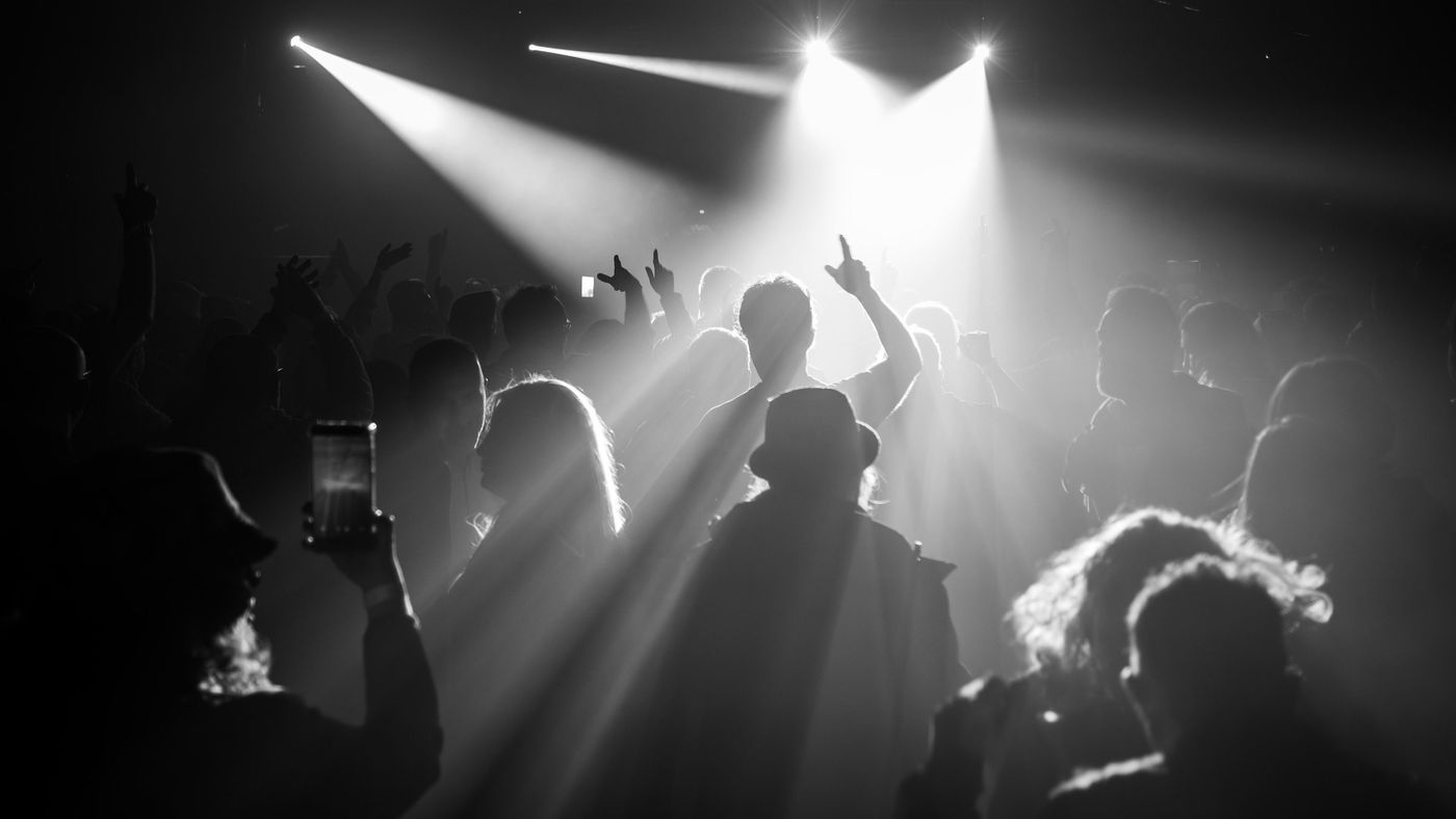 Band performing in silhouette on stage