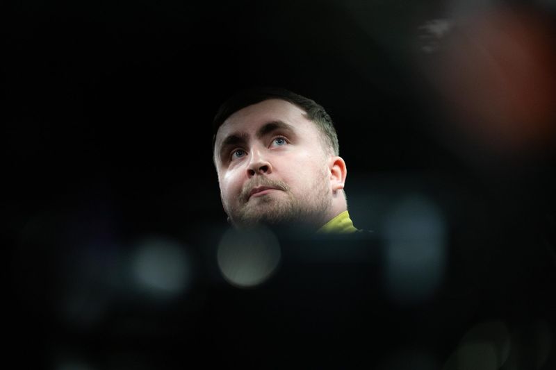 Competitor looking up under dark arena lights